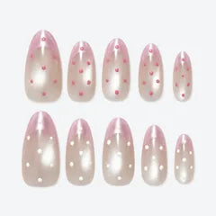 A set of sheer pink Dewdrop press-on nails dotted with white.