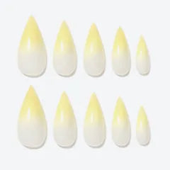 A set of long tapered Dragon press-on nails in a soft yellow gradient.