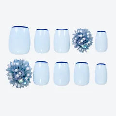 A set of pale blue Signature Beads press-on nails with a beaded crystal flower.