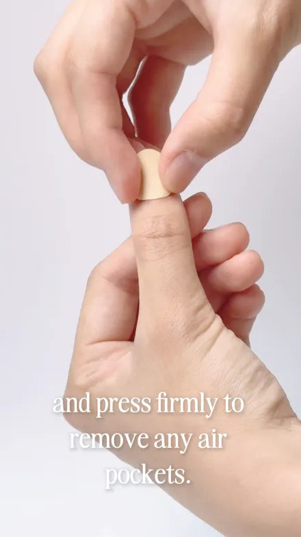 Step 5 of 10. Press firmly to remove any air pockets — a tab being pressed down onto the natural nail.