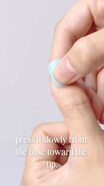Step 8 of 10. Press it slowly from the base toward the tip — the press-on being rolled down onto the nail.