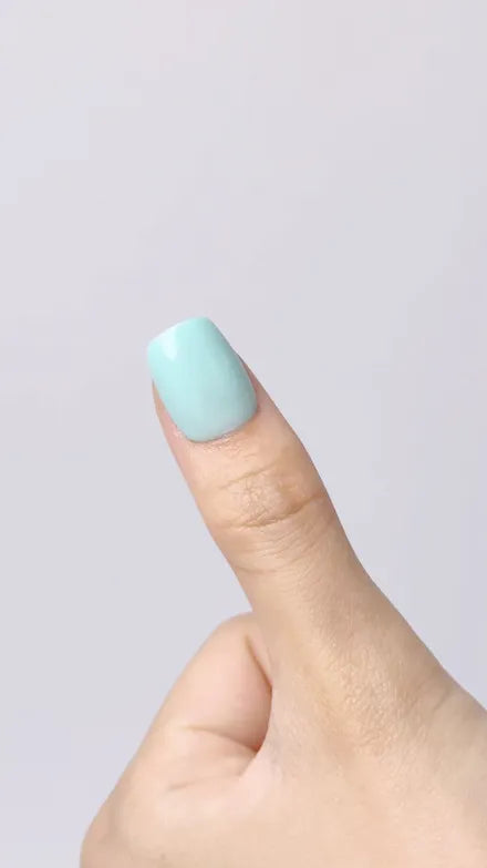 Step 10 of 10. The finished nail: a mint press-on sitting flush on the natural nail.