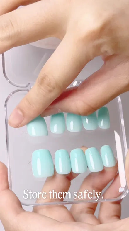 Step 3 of 4. Store them safely — a full set of mint press-ons being set back into their clear case.